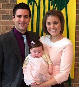 happy adoptive parents show off their new baby